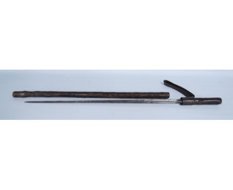 Antique sword stick contained in a tooled leather scabbard with truncheon strap, blade length 51cm. 