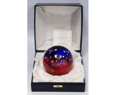 Caithness 'Crescendo' limited edition glass paperweight designed by Colin Terris, decorated with ruby fronds around silvery b