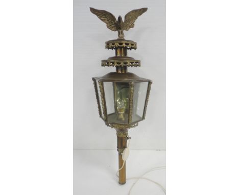 Brass carriage lamp with eagle surmount and hexagonal glazed tapered sides, probably of German origin, attached wall mount an