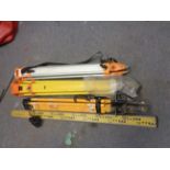 Three surveyors laser level tripods and measuring staff