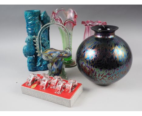 A spherical iridescent glass vase, two Victorian style ruby and green glass vases, a boxed set of glass napkin rings and a mu