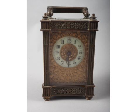 An early 20th century carriage clock with pierced and gilt decoration, 5" high 