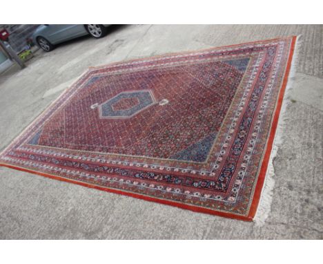 A Herati carpet with hexagonal medallion to the centre ground and multi-bordered in rainbow shades, 119" x 68" approx 