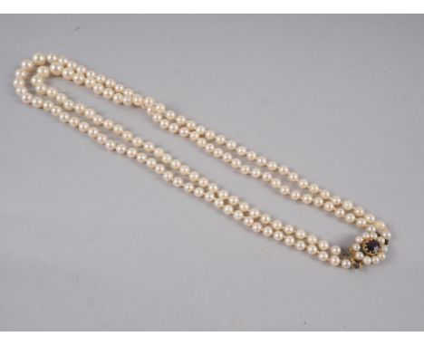 A two-string graduated pearl necklace with 9ct gold, garnet and pearl clasp 