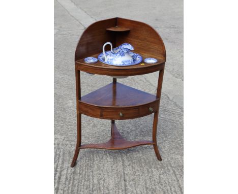 An Edwardian bowfront corner washstand, fitted single central drawer with Minton blue transfer decorated ceramic basin, jug a
