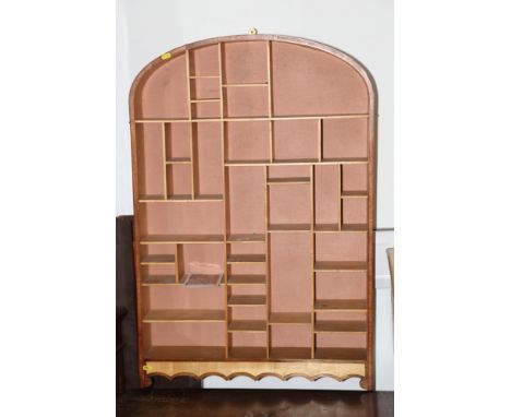 A bespoke birch and mahogany arch top wall display shelf with numerous pigeonholes, 27" wide x 4 3/4" deep x 43" high