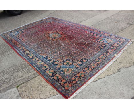 A Persian carpet of Herati design on a pink ground with blue floral borders, 128" x 82" approx 