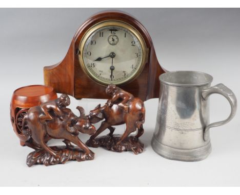 A 20th century mantel clock in mahogany case, a pair of Chinese carved wooden buffalo models and a Chinese pewter quart tanka