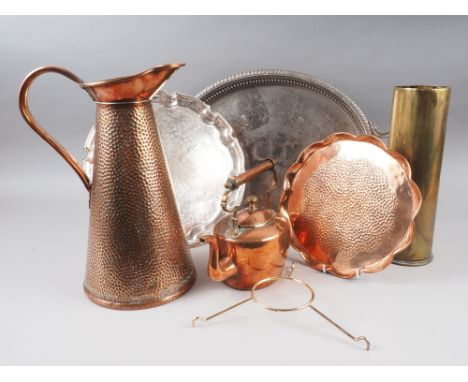 A hammered copper jug with tapering sides, a brass shell case, an oval copper kettle, a copper tray and two silver plated tra