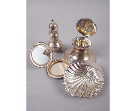 A silver capstan inkwell, a silver pepperette, a silver powder compact, a silver shell butter dish and a cased set of five si