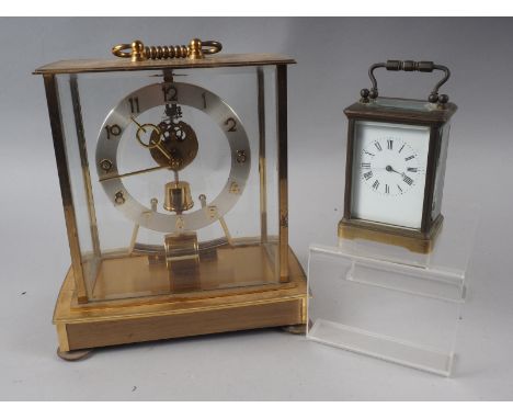 A Kundo battery operated mantel clock and a brass carriage clock (glass side panel broken) 