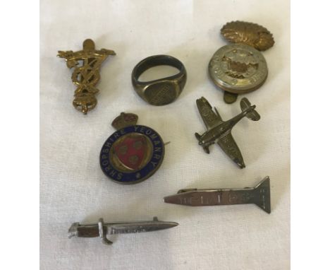 A collection of military badges & WW1 Armentieres ring. Comprising 2 cap badges (Royal Welch Fusiliers & another), an enamel 