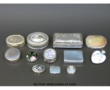 A collection of hallmarked silver, white metal and other pill and similar boxes including hallmarked silver topped enamel sce