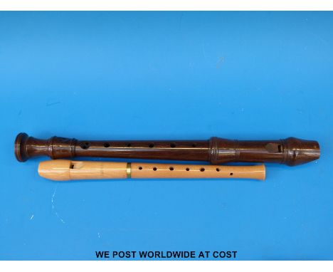 A Kung rosewood descant recorder together with a maple wood Hermann Moeck Celle Flote recorder (both in soft cases)