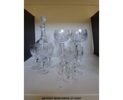 A globe shaped cut glass decanter together with matching glasses and six hock glasses.