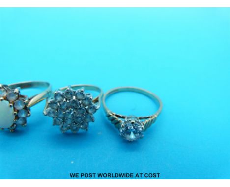 Three 9ct gold rings set with cubic zirconia and one set with an opal  