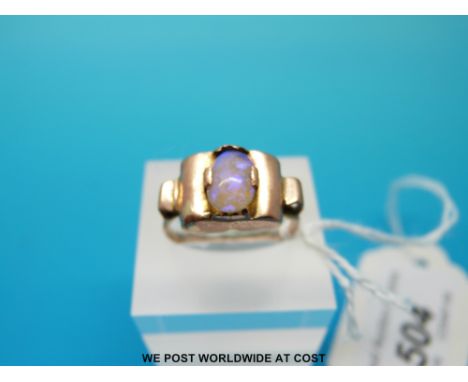 A yellow metal ring set with an opal in a barrel shaped setting, size O (2.6g) 