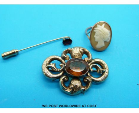 A 9ct gold ring set with a cameo, a yellow metal brooch set with a citrine and a 9ct gold stick pin set with a garnet 