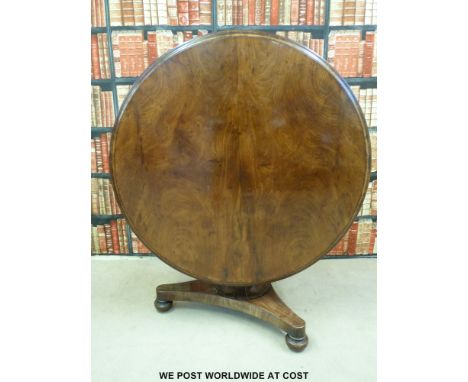 A Victorian mahogany breakfast table raised on a moulded tripod base and brass castors (Diameter 123cm)