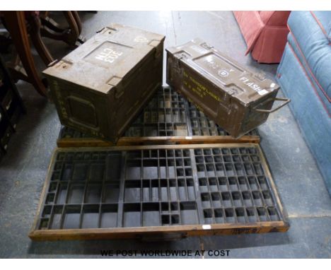 Two typesetter trays together with two ammunition boxes