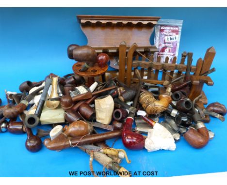 A quantity of pipe racks, pipes and lighters.