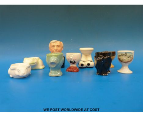 Ten assorted egg cups to include two Carlton ware and one featuring Rodborough fort