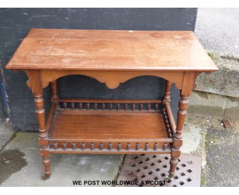 An oak occasional table with galleried shelf below 