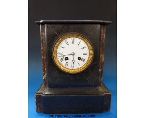 A French black marble mantel clock striking on a bell with white enamel dials and gilt bezel