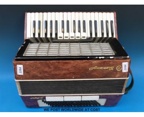 A 120 bass Russian piano accordion in peuse pearloid finish, 5 couplers on treble and three couplers to the bass.