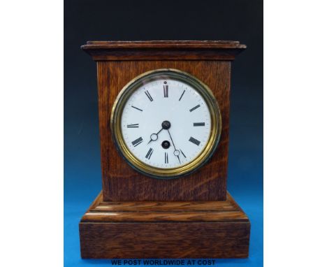 An oak cased mantel clock with single train French movement