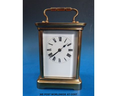 A brass carriage clock and case