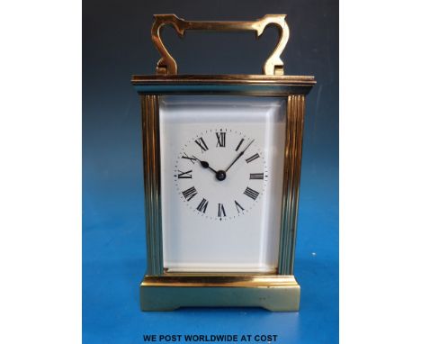 A brass carriage clock with certificate from Garrard and Co.