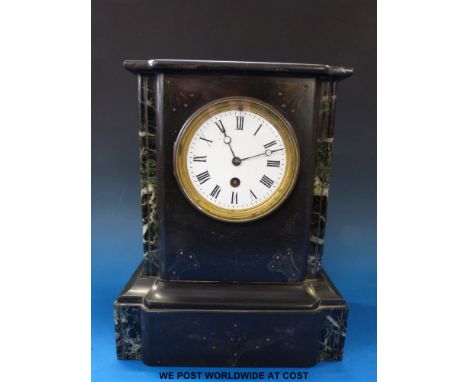 A single train black slate mantel clock with marble columns, the white enamel face with Roman numerals 