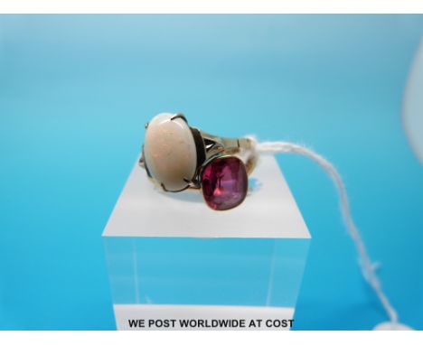 A yellow metal ring set with a ruby/ pink sapphire and a yellow metal ring marked 9ct set with an oval opal cabochon, size K 