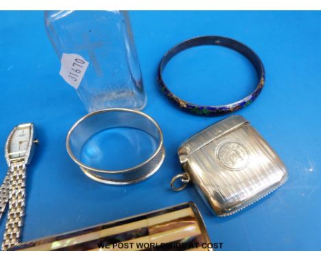 A hallmarked silver vesta, hallmarked silver napkin ring, two silver brooches in the form of cats, white metal bangle with en