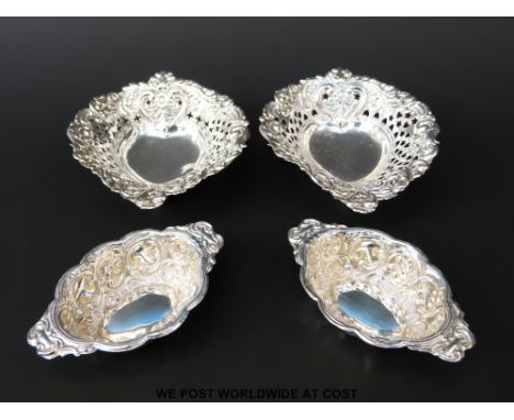 A pair of Victorian hallmarked silver pierced and embossed trinket dishes together with a pair of embossed two handled bowls,