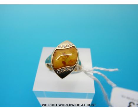 A 9ct gold ring set with pressed amber and diamonds, size K (3.4g) 
