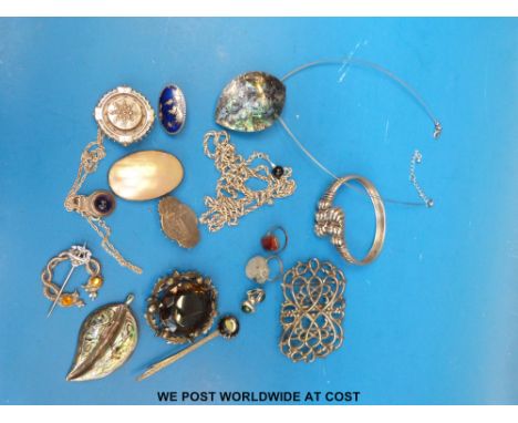A silver and pearl pendant, hallmarked silver buckle, Victorian silver and other brooches, white metal bangle, large silver n