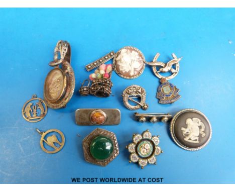 A white metal brooch in the form of a snake with opening glass compartment, four silver brooches, Army Ordnance and Wedgwood 