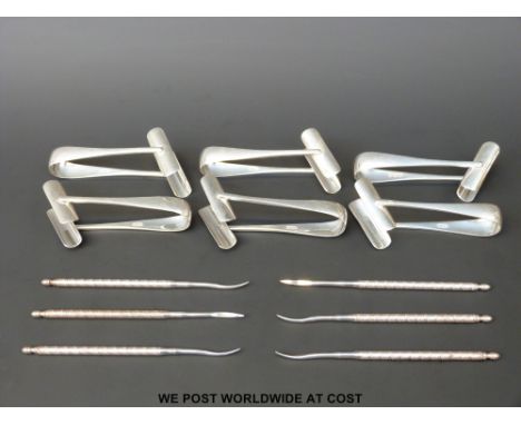 A set of six hallmarked silver asparagus holders, London 1945, maker CA.GA (weight 131g) and six plated tools 