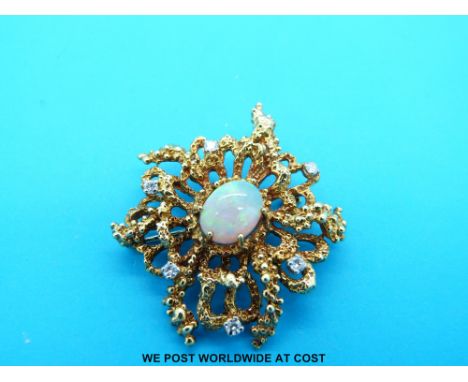 An 18ct gold brooch set with diamonds and a central opal cabochon