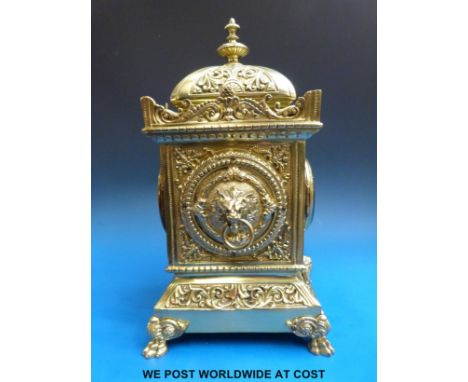 A French brass-cased Lantern mantel clock with Brevete Sonnerie movement, raised on lion paw feet, lion head handles to case