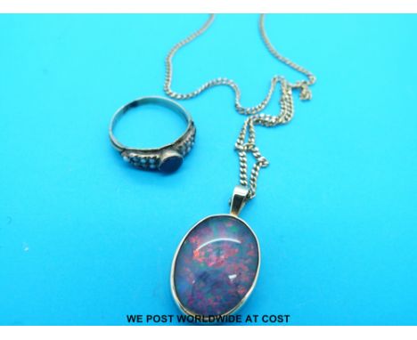 A 9ct gold chain with a yellow metal pendant set with an opal and a 9ct gold ring set with garnets and seed pearls 