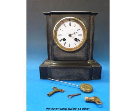 A small slate mantel clock striking on a chiming bell, serial no. 1291 with three keys and matching pendulum.