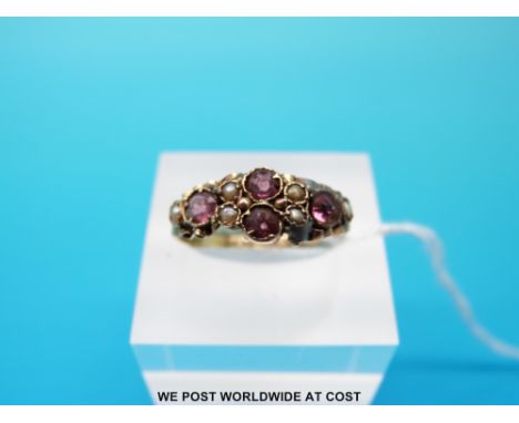 A Victorian yellow metal ring marked 12ct gold set with seed pearls and garnet, size R (1.4g) 