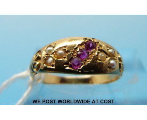 A 9ct gold ring set with three rubies and seed pearls, size K (2.3g) 