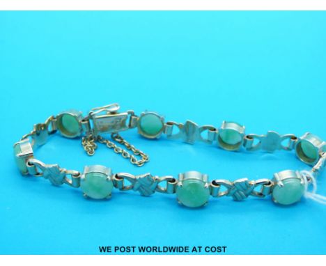 A 9ct gold bracelet set with jade cabochons