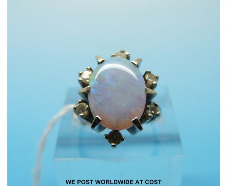 An 18ct white gold ring set with an oval opal surrounded by diamonds, size L (6.1g)  