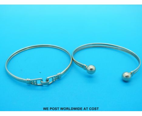 A 9ct gold bangle made up of two sections and a yellow metal bangle (12.2g)