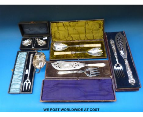 A cased hallmarked silver pickle fork, ivory handled cased salad server, two sets of fish servers, cruet set etc